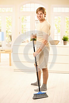 Guy sweeping the floor