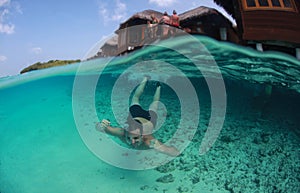 Guy swimming in the oceans sea, Maldives