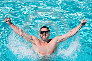 Guy in swimming pool water. Pool spa resort. Summertime vacation. Summer man.