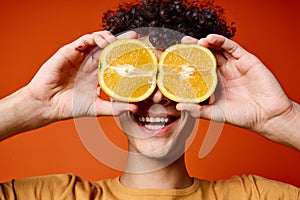 guy t-shirt with orange in his hands fruit healthy food