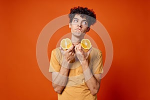 guy t-shirt with orange in his hands fruit healthy food