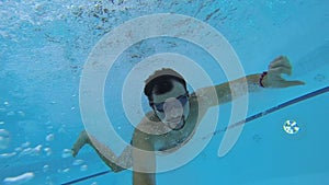 Guy taking video of self while running, jumping in pool and swimming underwater