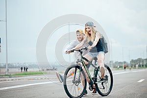 Guy teach his girl to ride a bike