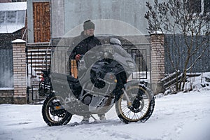 The guy took his motorcycle outside, turned on the engine and warmed it up,