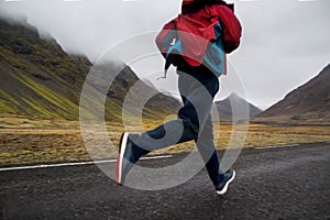 Guy tourist running in the mountains of Iceland, hoto in motion