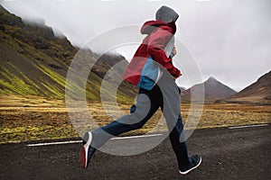 Guy tourist running in the mountains of Iceland, hoto in motion