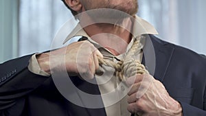 Guy trying to take off death rope from his neck, binding commitment, powerless