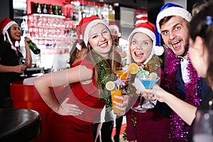 Guy with two girls on new year party in bar