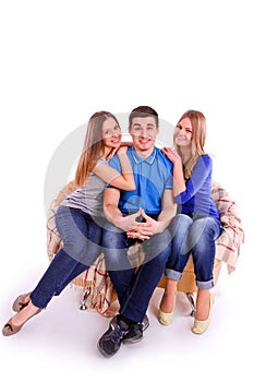 Guy with two girls sitting on the couch