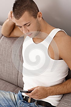 Guy in undershirt texting