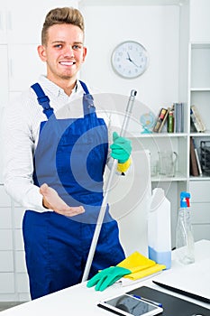 guy in uniform cleaning in office.