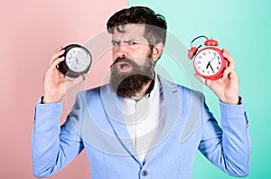 Guy unshaven puzzled face having problems with changing time. Time zone. Does changing clock mess with your health. Man