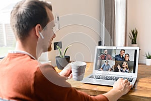 A guy is using laptop for video call, zoom photo