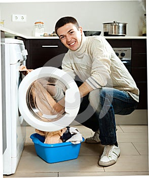 Guy using washing machine