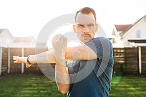 A guy warms up before outdoors workout