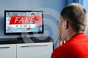 The guy watching the fake news on TV. Corrupt journalism.