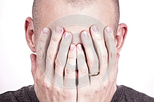 Guy who holds his hands to his face and crie photo