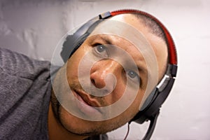Guy wincing with headphones portrait young head photo
