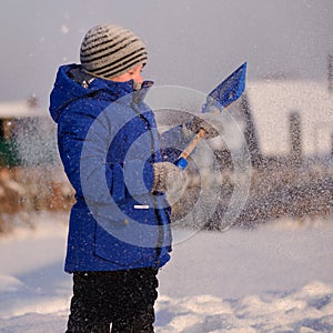 Child in winter clothes outside the city on the background of a