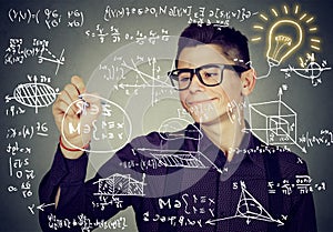 Guy writing high school maths and science formulas