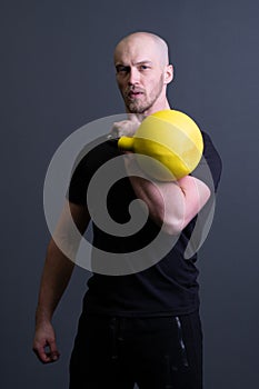 Guy with a yellow kettlebell gym anonymous yellow male, for fit effort from picking for up youth, vietnamese activity