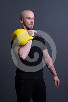 Guy with a yellow kettlebell gym anonymous young man, in the afternoon fit lifestyle in strong for floor sportswear