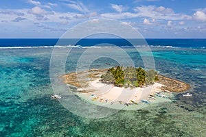 Guyam island, Siargao, Philippines. Small island with palm trees and a white sandy beach.