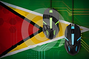 Guyana flag and two mice with backlight. Online cooperative games. Cyber sport team