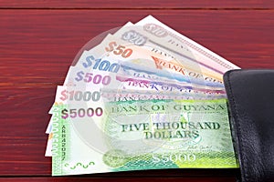 Guyanese money in the black wallet