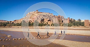 Guys crossing the river in Kasbah Ait Ben Haddou in Morocco. A lot of movies was made there