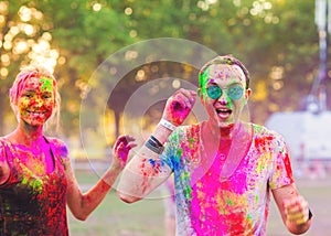 Guys with a girl celebrate holi festival