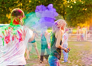 Guys with a girl celebrate holi festival