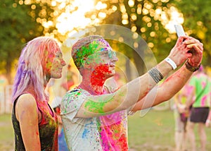 Guys with a girl celebrate holi festival