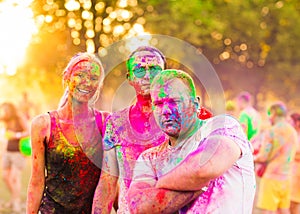 Guys with a girl celebrate holi festival