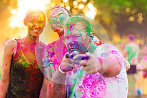 Guys with a girl celebrate holi festival