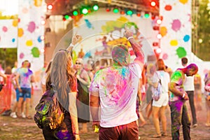 Guys with a girl celebrate holi festival