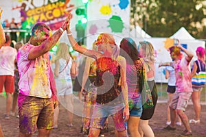 Guys with a girl celebrate holi festival