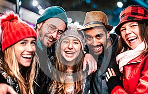 Guys and girls best friends taking selfie on warm fashion clothes at night - Happy life style concept with milenial people