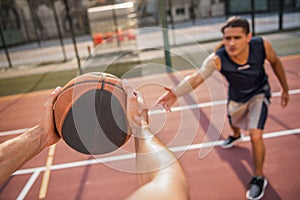 Guys playing basketball