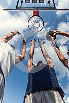 Guys playing basketball