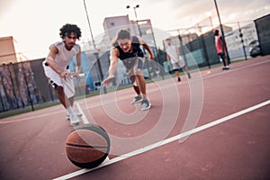 Guys playing basketball