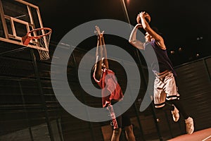 Guys playing basketball