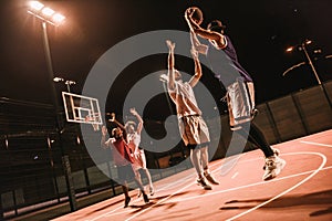 Guys playing basketball