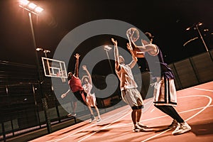 Guys playing basketball