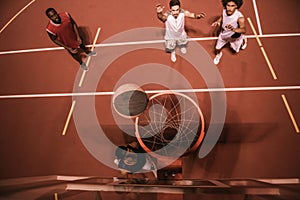 Guys playing basketball