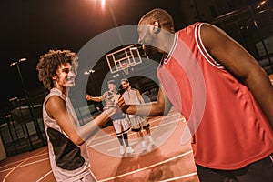 Guys playing basketball