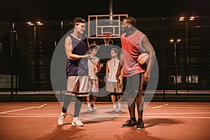 Guys playing basketball