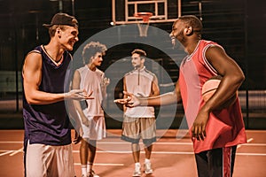 Guys playing basketball