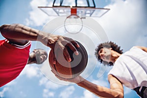 Guys playing basketball