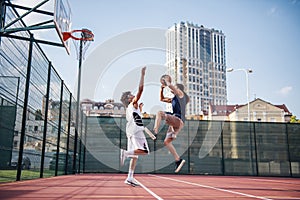 Guys playing basketball